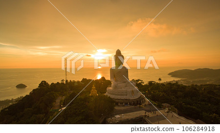 aerial view colorful yellow cloud in golden sky in sunset at Phuket big Buddha. creative travel concept. stunning yellow sky background. Phuket big Buddha is the popular landmark in Phuket. 106284918