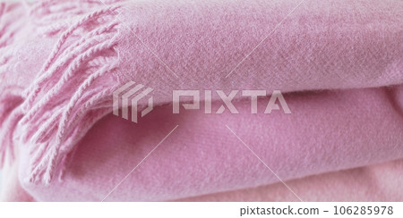 Cashmere texture, natural wool, pink cashmere clothes folded on the table, fabric background, concept of warmth and comfort Cashmere texture, natural wool, pink cashmere clothes folded on the table, fabric background, concept of warmth and comfort 106285978