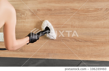 Concept of home cleaning and steam disinfection of the surface. Steam cleaning kitchen worktops with hot steam. Selective focus with copy space. 106289460