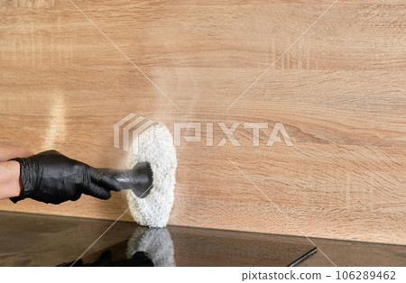 Concept of home cleaning and surface disinfection with steam. Steam cleaning of furniture with hot steam. Selective focus with copy space. 106289462
