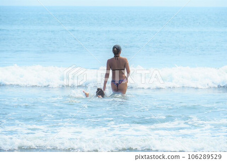 Young bikini-style woman playing in the blue sea, summer landscape 106289529