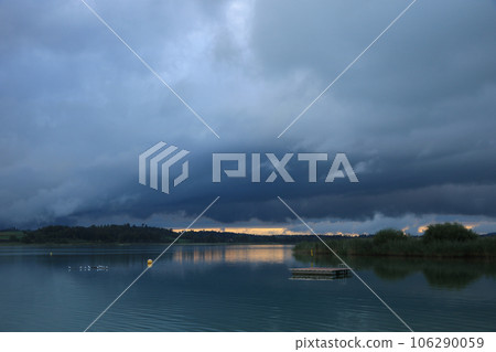 Dark clouds and bright sunlight over Lake Pfaeffikon, Zurich. 106290059