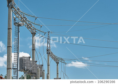 High voltage electrical transformers in an electricity distribution power plant. High voltage power lines, life power supply. Close-up High voltage electrical transformers in an electricity distribution power plant. High voltage power lines, life power supply. Close-up 106290166