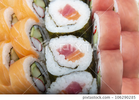 Sushi rolls with salmon and tuna , close up shot Sushi rolls with salmon and tuna , close up shot 106290285