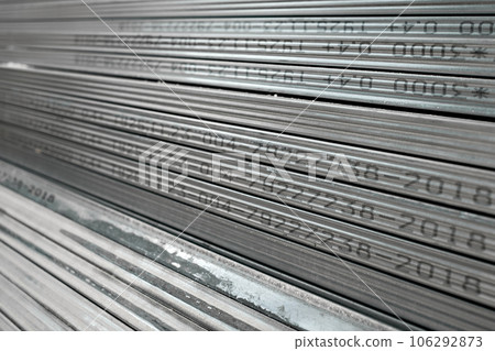 Metal profiles for drywall stacked in stock and ready for delivery to the buyer, selective focus Metal profiles for drywall stacked in stock and ready for delivery to the buyer, selective focus 106292873