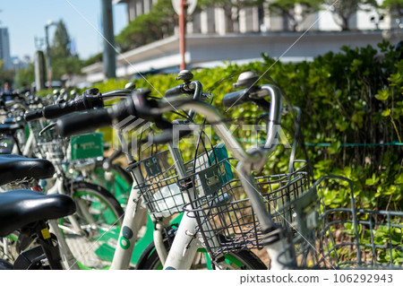 Bicycle Docking Station parking next to park in Seoul, South Korea. It is the rental system designed to resolve issues of traffic congestion, air pollution in the city. Bicycle Docking Station parking next to park in Seoul, South Korea. It is the rental system designed to resolve issues of traffic congestion, air pollution in the city. 106292943
