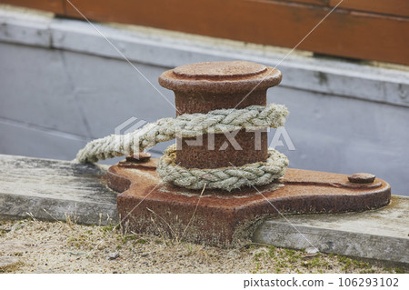 Rusty bollard and mooring lines on an old pier in Denmark Rusty bollard and mooring lines on an old pier in Denmark 106293102