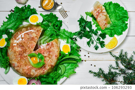 Homemade pork and beef jellied meat. Traditional Russian dish aspic on a white wooden table. Top view, flat lay. Serving and serving dishes Homemade pork and beef jellied meat. Traditional Russian dish aspic on a white wooden table. Top view, flat lay. Serving and serving dishes 106293293