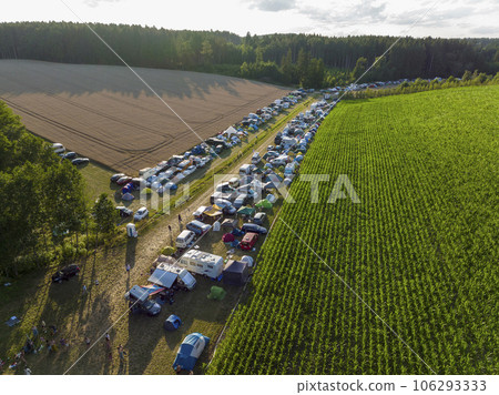 Aerial Drone Shot at Plenty of tents and Campers at a festival campsite. Camping Area Outdoors at Nature,a Open Air Fest Aerial Drone Shot at Plenty of tents and Campers at a festival campsite. Camping Area Outdoors at Nature,a Open Air Fest 106293333