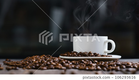 White cup with espresso coffee and grains on a wooden dark table 106293616