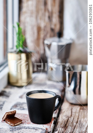 Mocha mug, steam rises above the cup, close-up, selective focus. Background from bricks and old wood Mocha mug, steam rises above the cup, close-up, selective focus. Background from bricks and old wood 106293861