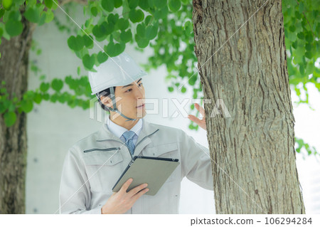 Man in work clothes Roadside trees Man in work clothes Roadside trees 106294284