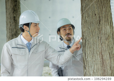 Man in work clothes Roadside trees Man in work clothes Roadside trees 106294289
