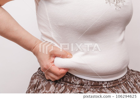[Housewife picking meat from her belly] 106294625