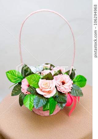 Bouquet of fragrant flowers from handmade soap in a wicker basket on a white background Bouquet of fragrant flowers from handmade soap in a wicker basket on a white background 106294968