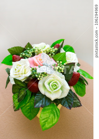 Bouquet of fragrant flowers from handmade soap in a wicker basket on a white background Bouquet of fragrant flowers from handmade soap in a wicker basket on a white background 106294969