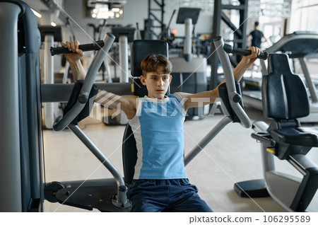 Active teenager boy doing physical exercise for masculinity development Active teenager boy doing physical exercise for masculinity development 106295589