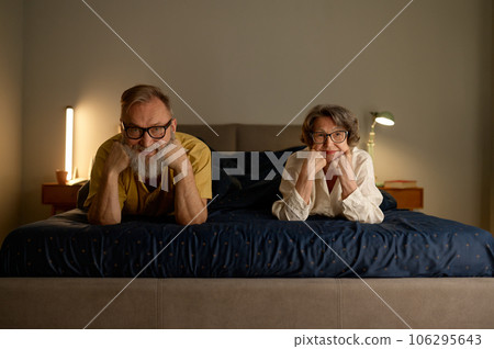 Portrait of smiling senior family couple in bed Portrait of smiling senior family couple in bed 106295643