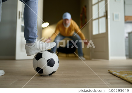 Happy couple of retiree playing football, selective focus of foot on ball Happy couple of retiree playing football, selective focus of foot on ball 106295649