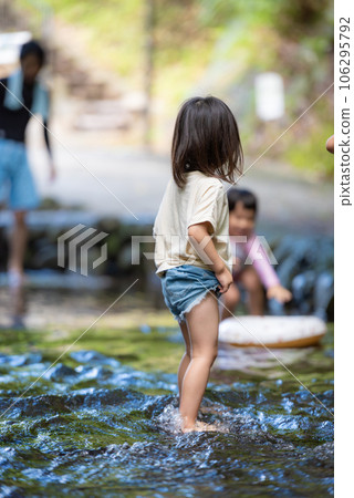 Little girl playing in the stream 106295792