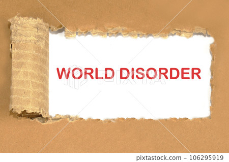 The phrase WORLD DISORDER the inscription appearing behind the torn cardboard paper The phrase WORLD DISORDER the inscription appearing behind the torn cardboard paper 106295919