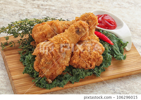 Fried chicken drumsticks with tomato sauce 106296015