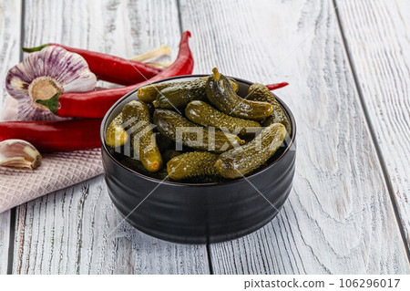 Marinated small cucumbers in the bowl Marinated small cucumbers in the bowl 106296017
