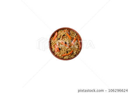 Delicious Uzbek pilaf with chicken, carrots, barberry, spices and herbs 106296624
