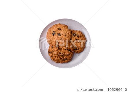 Delicious baked oatmeal raisin cookies on a dark concrete background 106296640