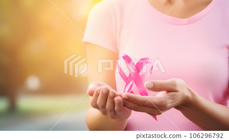 Hands of women holding pink heart for breast cancer day concept 106296792