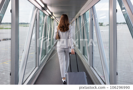 Businesswoman boarding the plane with carry-on 106296990