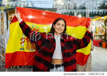 Girl waving Spain flag at street new year fair 106297116
