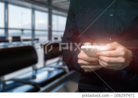 A man works on a virtual screen with a world map. A man works on a virtual screen with a world map. 106297471