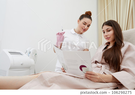 Detailed beauty discussion led by young cosmetologist with interested patient 106298275