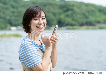 Woman refreshing at the lake Woman traveling Woman traveling Woman going on holiday 106299400