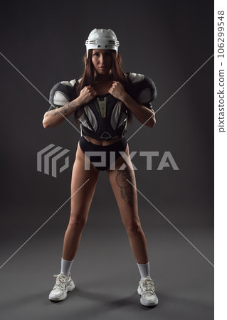 Female rugby player in lingerie on black background Female rugby player in lingerie on black background 106299548