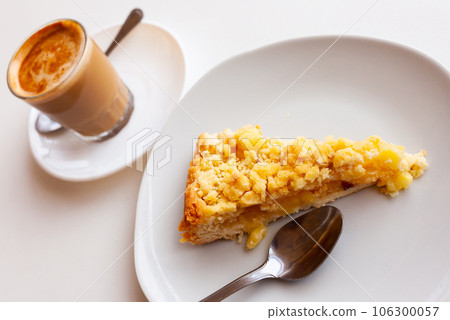 Dutch apple pie slice served with glass of hot chocolate Dutch apple pie slice served with glass of hot chocolate 106300057