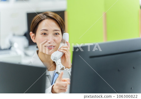 Female worker making a phone call in the office Female worker making a phone call in the office 106300822
