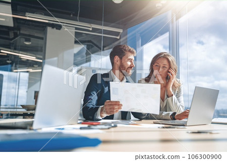 Businessmen talk phone and discussing their business looking at financial charts 106300900
