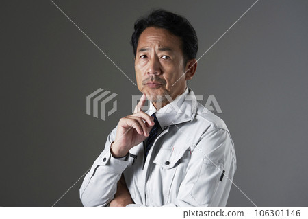Thinking middle-aged worker black background Thinking middle-aged worker black background 106301146