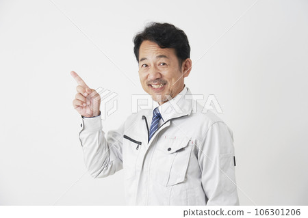 Middle-aged worker pointing to the left White background Middle-aged worker pointing to the left White background 106301206