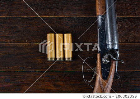 Antique 12-gauge break-action smooth-bored shotgun with paper cases. Antique 12-gauge break-action smooth-bored shotgun with paper cases. 106302359