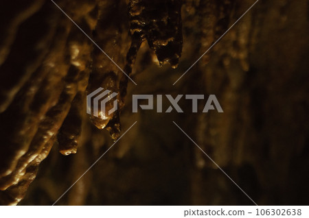 Image of rock surface and dark limestone cave 106302638