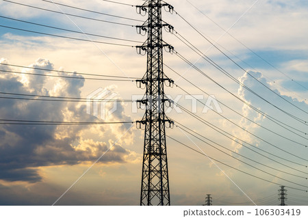 Transmission towers and cumulonimbus clouds in the summer afternoon and evening sky c-1 106303419