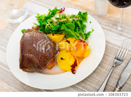Piece of juicy appetizing delicious grilled beef with vegetables salad served with fried potato 106303723