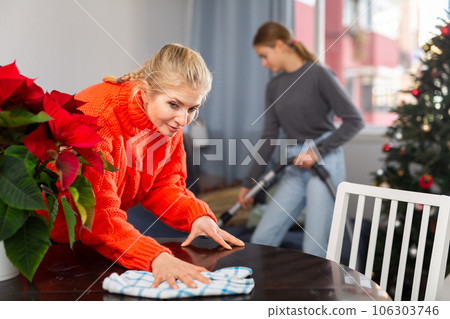 Mother and daughter cleaning room together before christmas Mother and daughter cleaning room together before christmas 106303746
