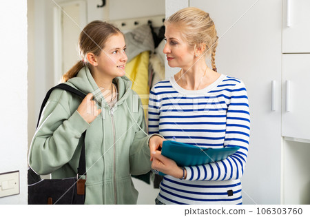 Woman answers questions of interviewer at home Woman answers questions of interviewer at home 106303760