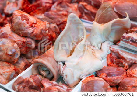 Variety meat in packing tray on glass window refrigerator of butcher shop. Variety meat in packing tray on glass window refrigerator of butcher shop. 106303761