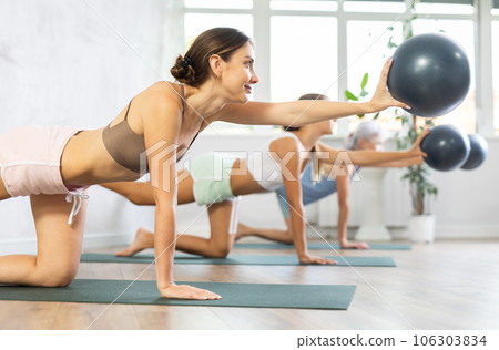 Sporty young woman training with bender ball at gym 106303834