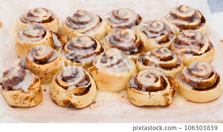 Cinnamon swirls on wooden background 106303839